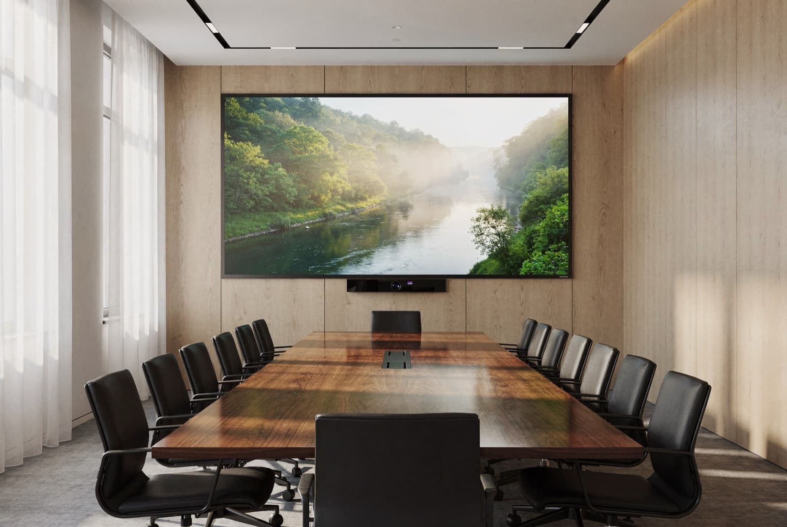 A boardroom with a large LED wall at the end of a long conference table, a video-conferencing camera mounted below it