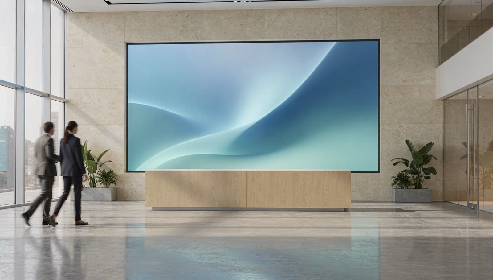 A seamless LED video wall set into the stone wall behind a reception desk in a bright corporate lobby