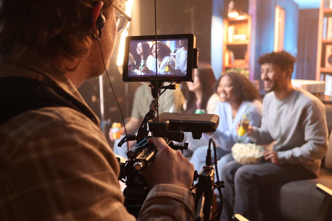 Camera operator filming talent on an LED volume virtual production stage